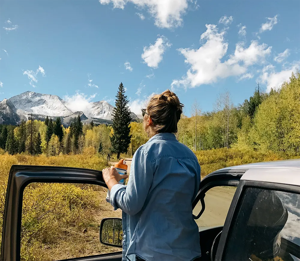 A woman confidently driving her car, representing peace of mind after resolving a Lemon Law claim.