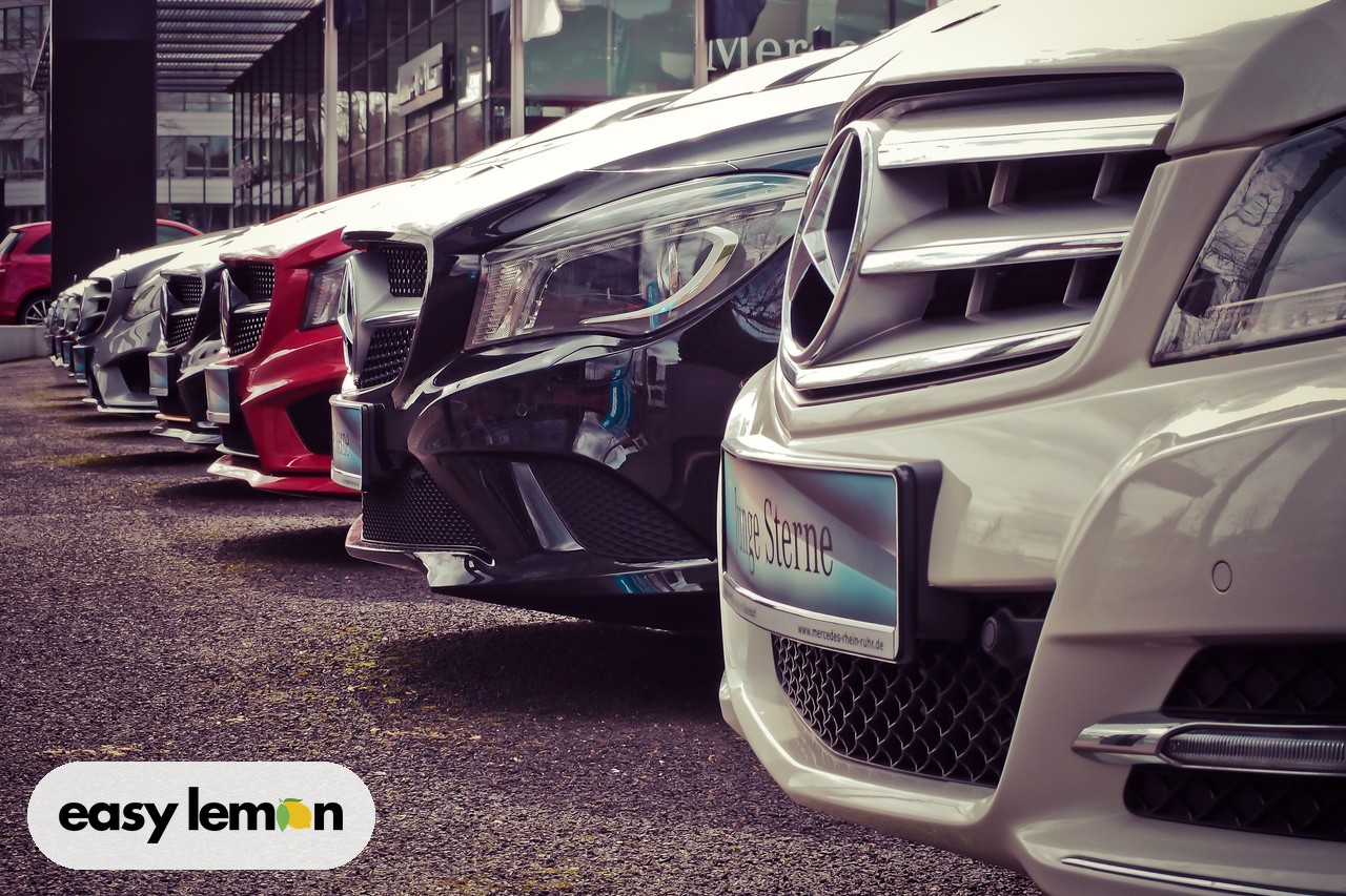 Lineup of cars from various brands at a dealership lot facing recalls