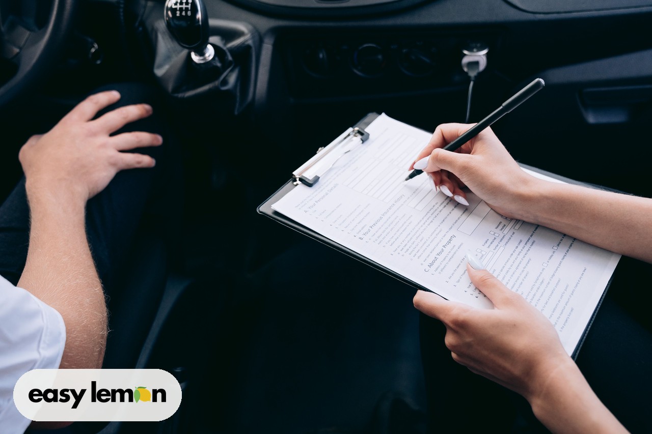 Car owner reviewing recall paperwork and documents on a clipboard inside a car