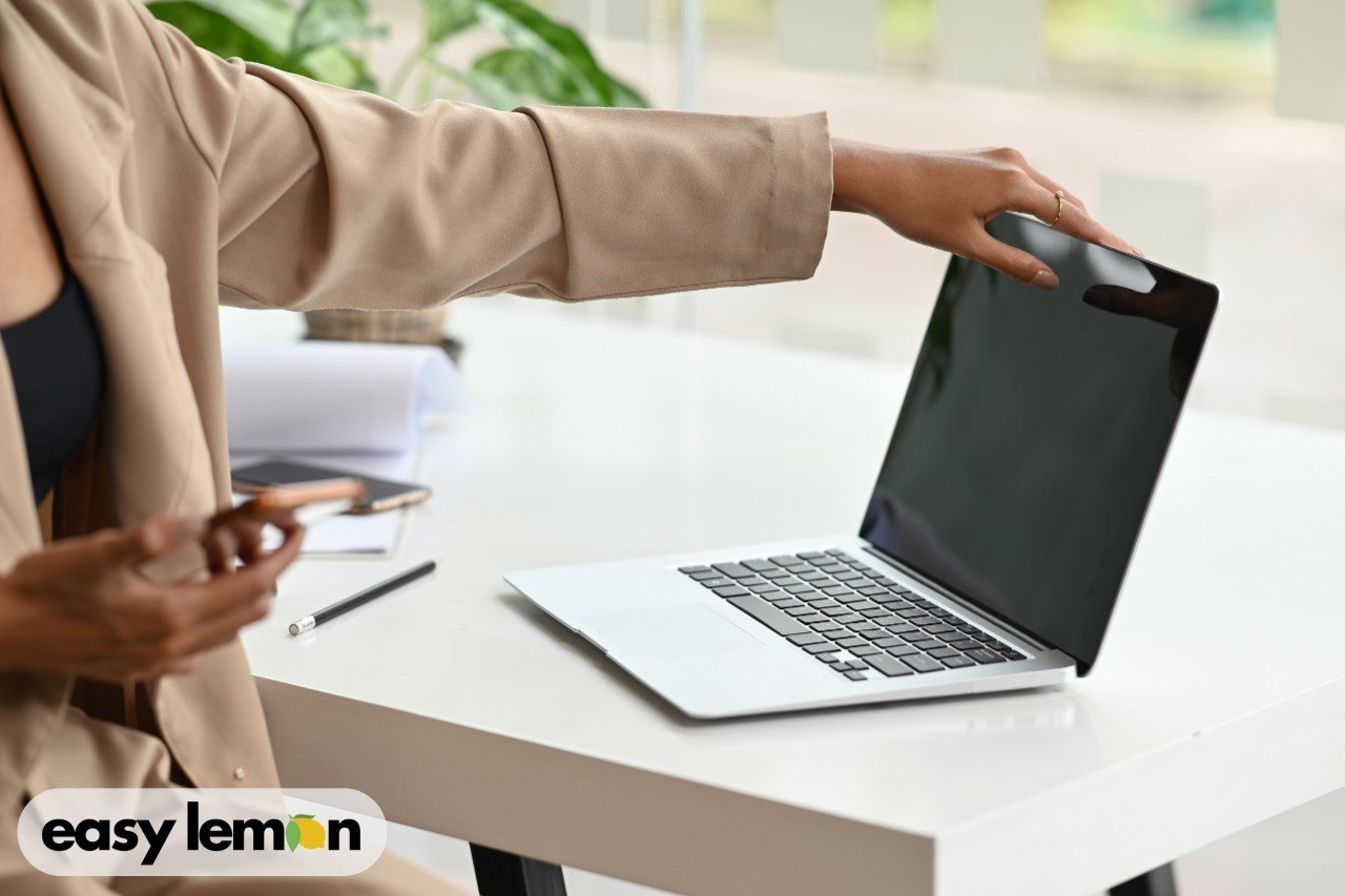 Person checking a vehicle recall history online on a laptop