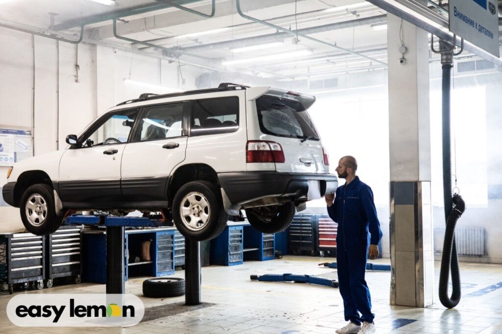 Mechanic inspecting a lifted SUV for common Bronco problems