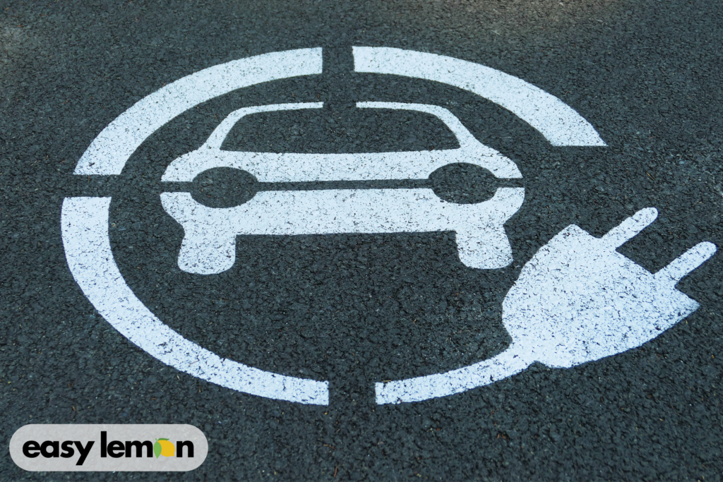 Electric vehicle charging symbol on pavement representing Jeep 4xe battery concerns related to Understanding Your Jeep