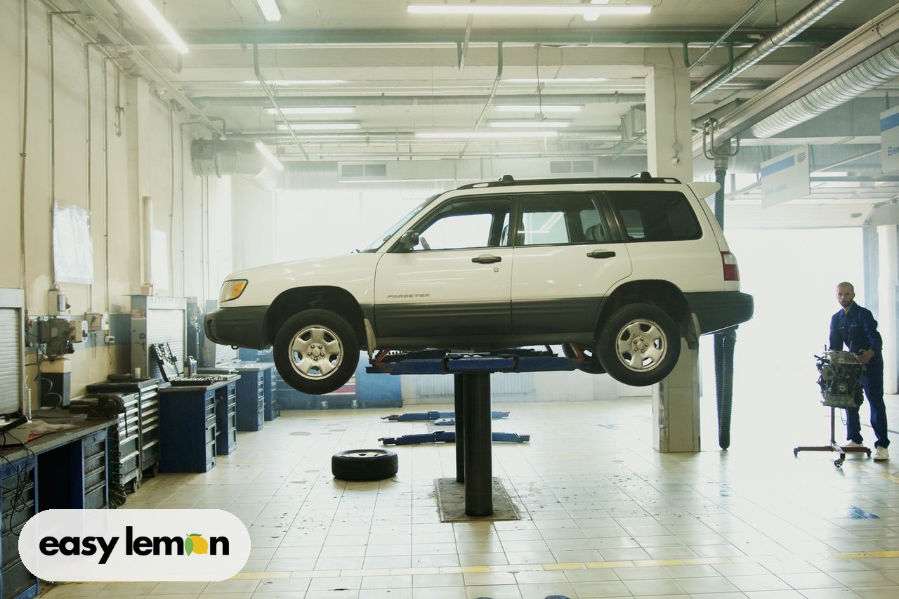 Mechanic repairing a car raised on a shop lift