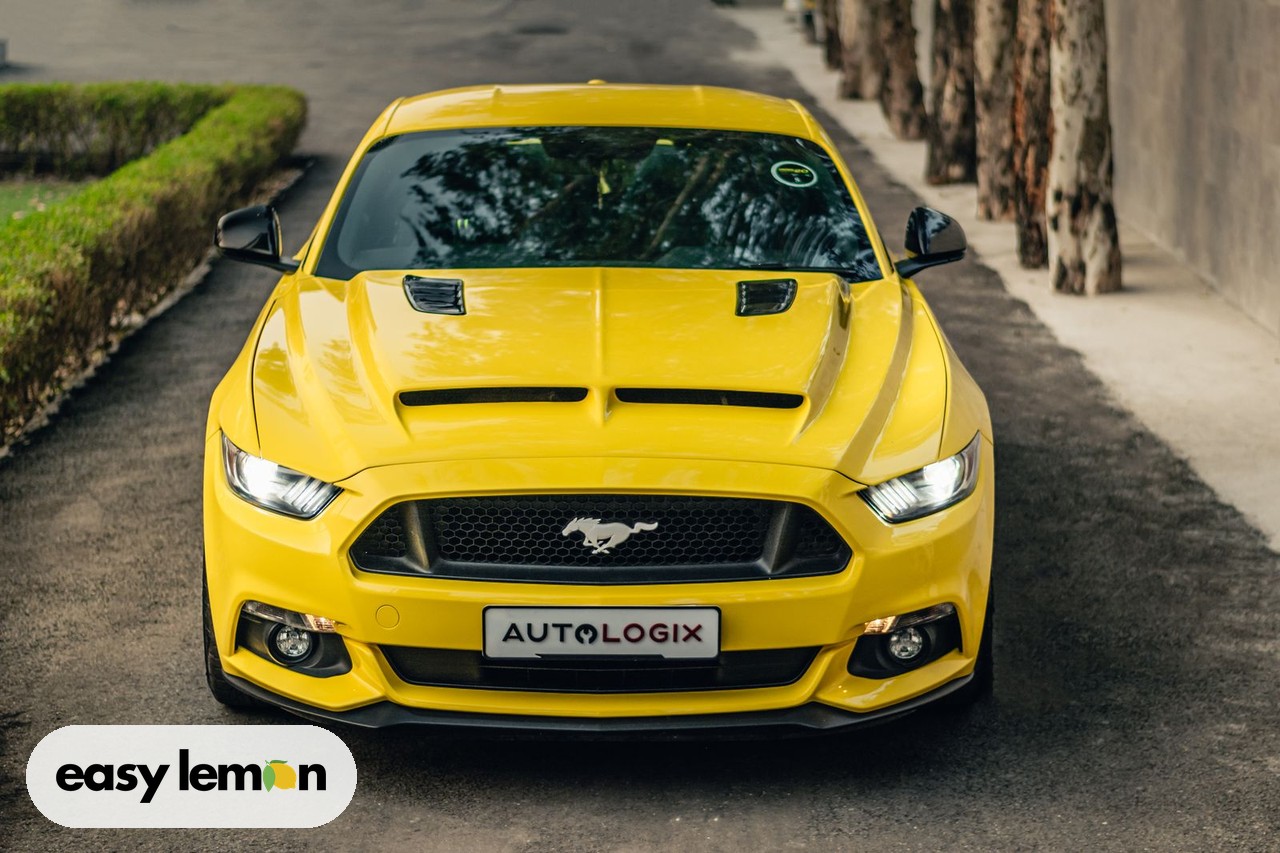 Yellow Ford Mustang sports car parked on a city street