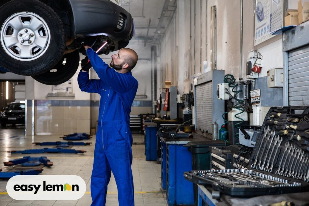 Mechanic working on a car during a dealership recall repair