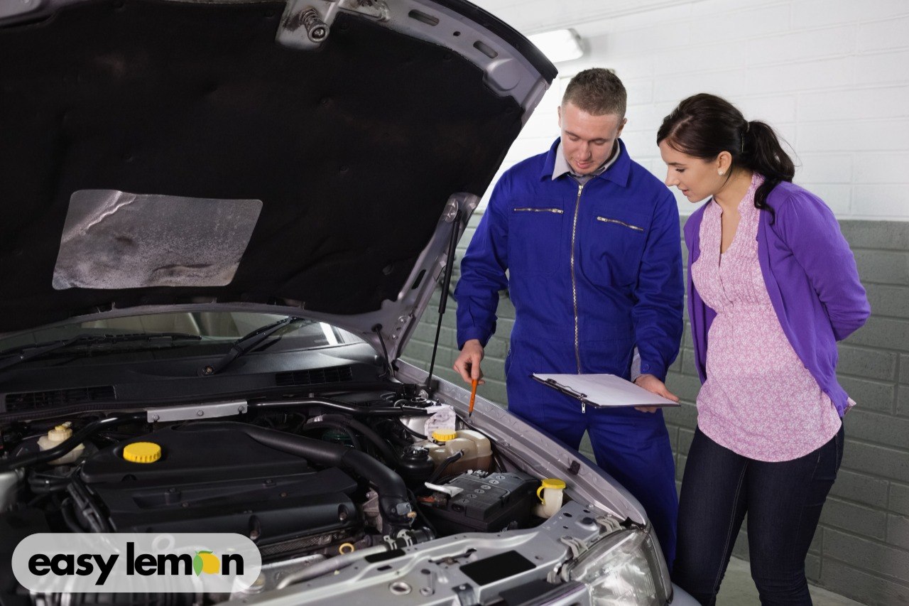 Mechanic inspecting a car engine for recall-related issues