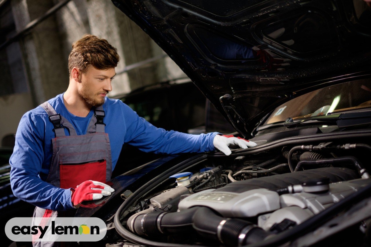 Mechanic inspecting a Dodge Ram engine to diagnose transmission problems