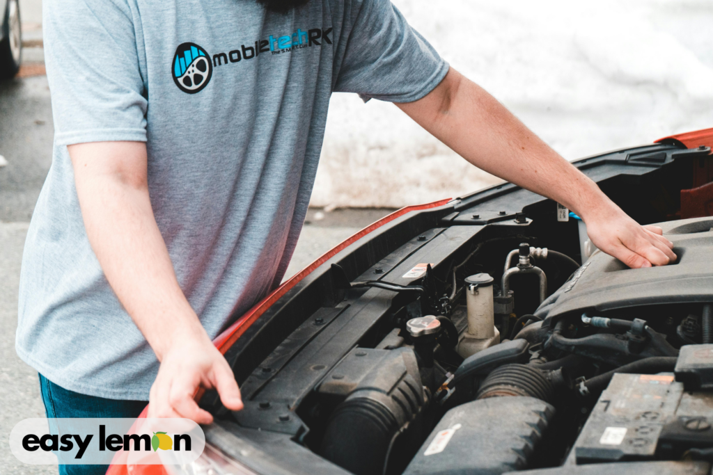 Mechanic inspecting a RAM truck engine as part of the ram lemon law timeline texas repair attempts requirement.