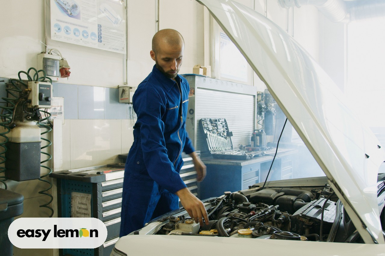 Mechanic inspecting a car engine during a recall repair